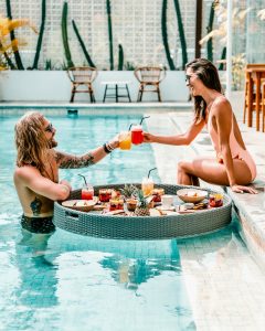 couple enjoying drinks at a pool party